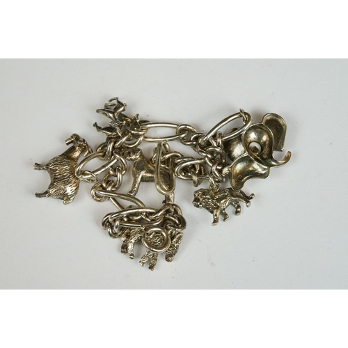 229 - A sterling silver charm bracelet together with six charms in the form of different animals.