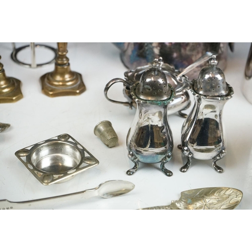 263 - A small collection of mixed silver plate to include teapot, spoons, thimbles, sugar shaker, taper st... 