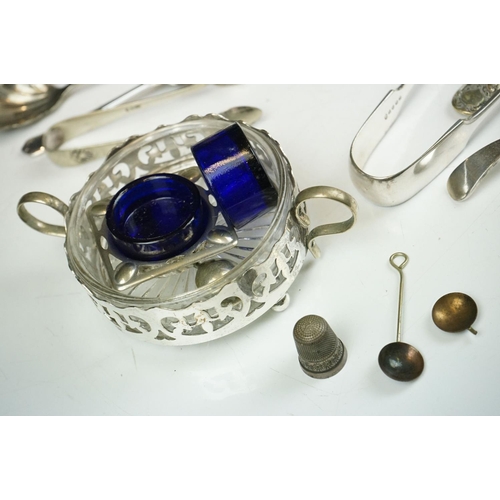 263 - A small collection of mixed silver plate to include teapot, spoons, thimbles, sugar shaker, taper st... 