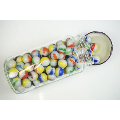 265 - A large collection of mainly glass marbles of varying sizes and colours.