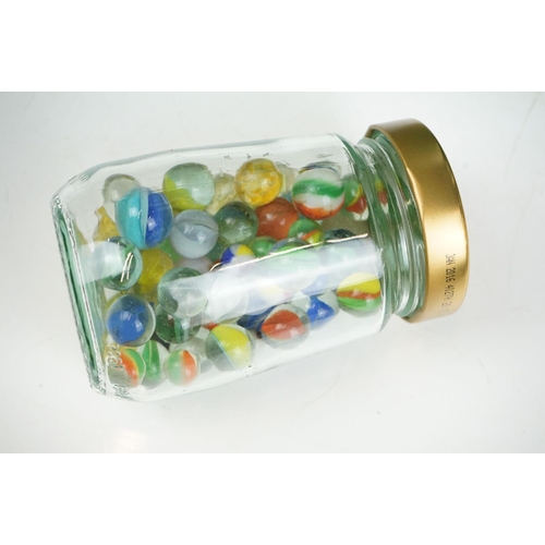 265 - A large collection of mainly glass marbles of varying sizes and colours.