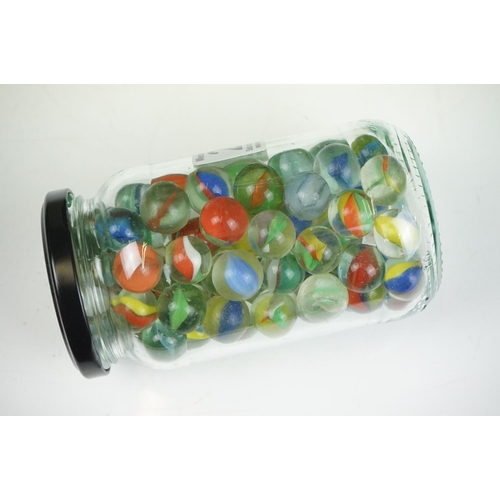 265 - A large collection of mainly glass marbles of varying sizes and colours.