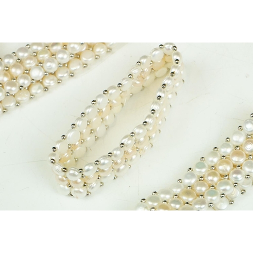 280 - A collection of approx twenty five natural pearl stretch bracelets.