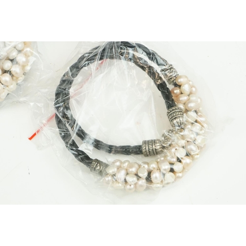 283 - Large collection of natural pearl leather bracelets of varying colours.