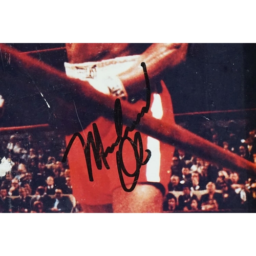 294 - Photograph of a Boxing Match between Muhammad Ali and Joe Frazier, bearing two signatures, photo mea... 