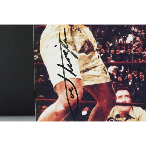 294 - Photograph of a Boxing Match between Muhammad Ali and Joe Frazier, bearing two signatures, photo mea... 