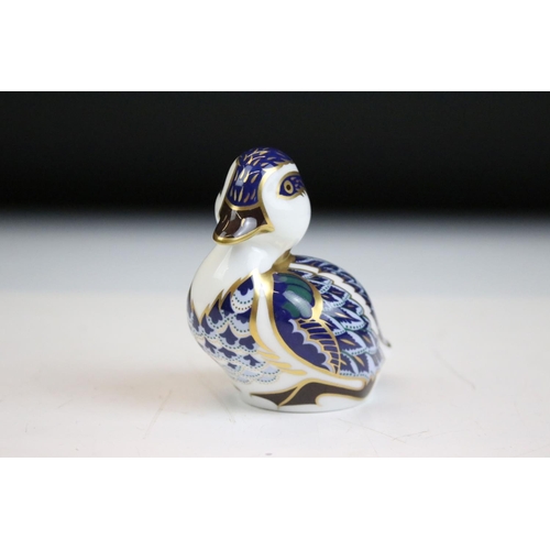 55 - Group of three Royal Crown Derby ceramic paperweights to include two birds with gold stoppers and on... 