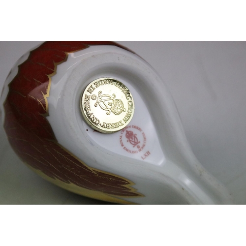 55 - Group of three Royal Crown Derby ceramic paperweights to include two birds with gold stoppers and on... 