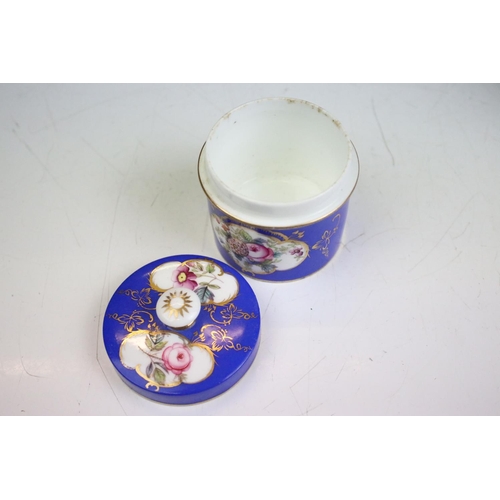 57 - Two porcelian dressing table pots, each having a blue ground with hand painted floral panels. Unmark... 