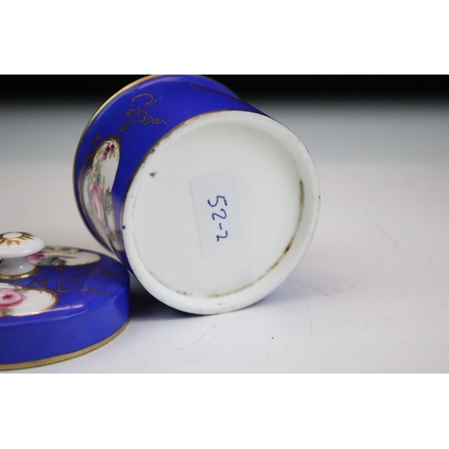 57 - Two porcelian dressing table pots, each having a blue ground with hand painted floral panels. Unmark... 