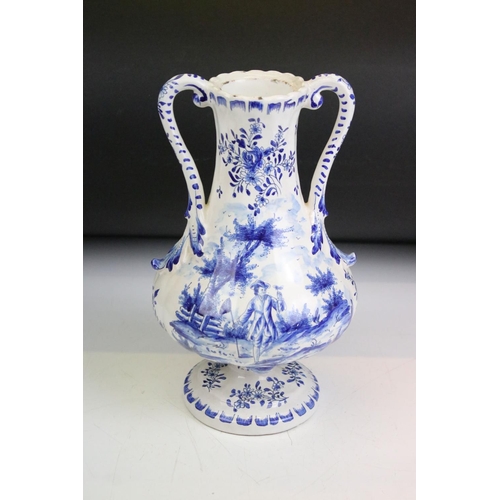 60 - Delft blue and white tin glazed twin handled vase having hand painted detailing featuring a butterfl... 