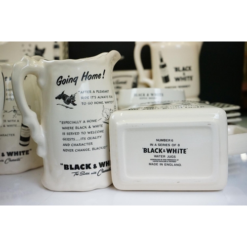 108 - Collection of Black & White scotch whisky advertising water jugs, clock ash trays, advertising terri... 