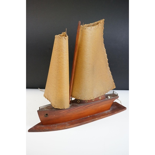 119 - Art Deco table lamp in the form of a boat of wooden construction with two hide sails. Measures 41cm ... 