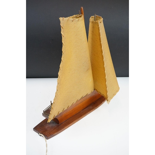 119 - Art Deco table lamp in the form of a boat of wooden construction with two hide sails. Measures 41cm ... 