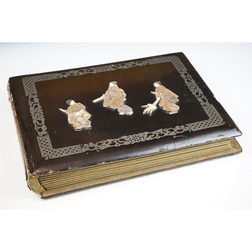 124 - Early 20th Century Japanese lacquer photograph / postcard album having applied mother of pearl figur... 