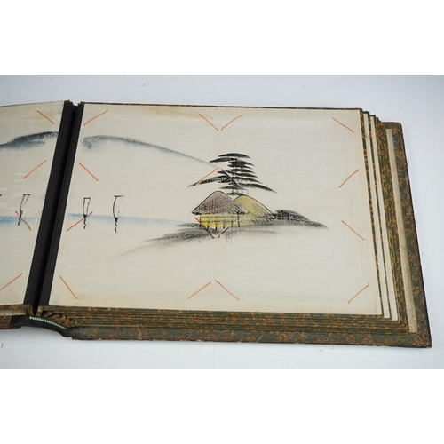 125 - Early 20th Century Japanese lacquer photograph / postcard album featuring a gilt landscape scene to ... 