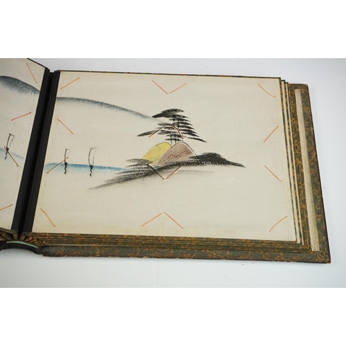 125 - Early 20th Century Japanese lacquer photograph / postcard album featuring a gilt landscape scene to ... 