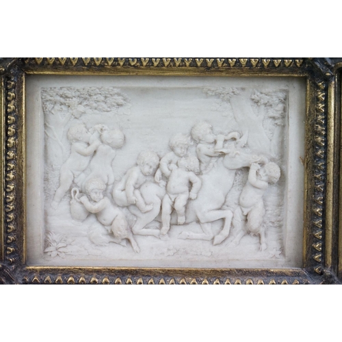 128 - Two 20th Century reconstituted stone relief wall plaques, one featuring three children, the other a ... 