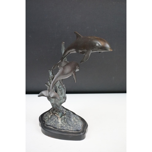 135 - An ornamental bronze of a Dolphin & Calf, stands approx 27cm in height.