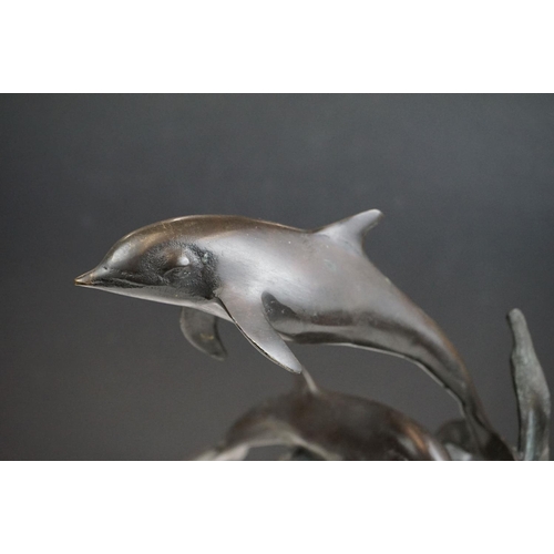 135 - An ornamental bronze of a Dolphin & Calf, stands approx 27cm in height.