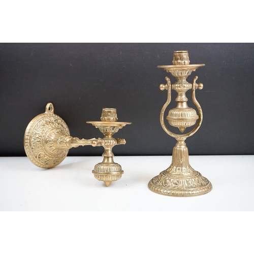 144 - A pair of brass standing or wall mounted candlesticks with gimble mounting.