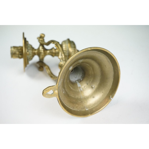 144 - A pair of brass standing or wall mounted candlesticks with gimble mounting.