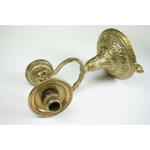 144 - A pair of brass standing or wall mounted candlesticks with gimble mounting.