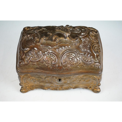 145 - 19th century Metal Jewellery Casket in the Rococo manner with foliate scroll casting, the hinged lid... 