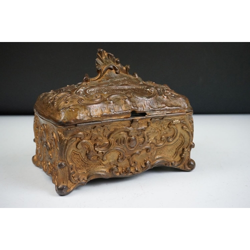 145 - 19th century Metal Jewellery Casket in the Rococo manner with foliate scroll casting, the hinged lid... 