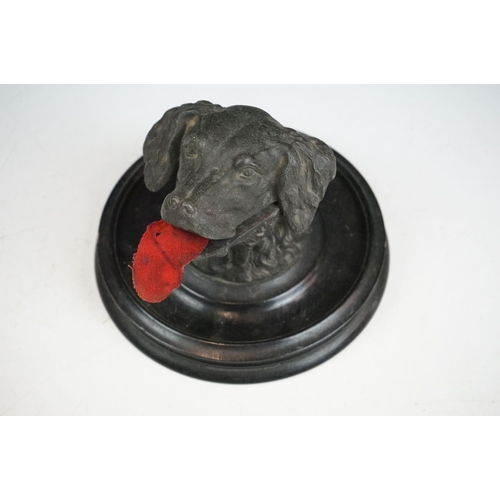 146 - A Victorian pewter inkwell in the form of a dogs head mounted on a turned black wooden base, complet... 