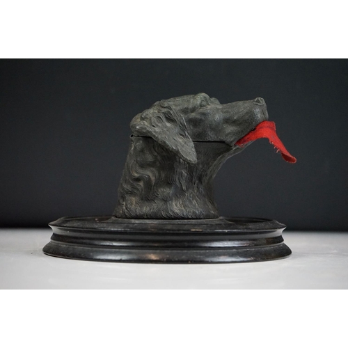 146 - A Victorian pewter inkwell in the form of a dogs head mounted on a turned black wooden base, complet... 