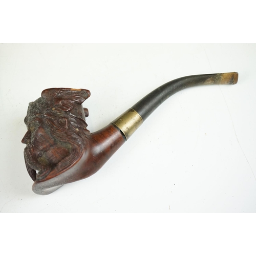 147 - An oriental carved wooden pipe rack with dragon decoration together with a pipe with Viking bowl.