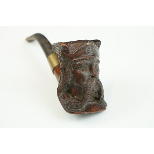 147 - An oriental carved wooden pipe rack with dragon decoration together with a pipe with Viking bowl.