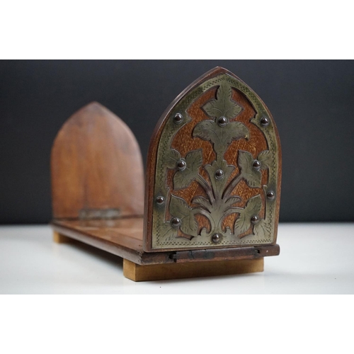 154 - An antique oak book slide with metal pierced floral decoration.