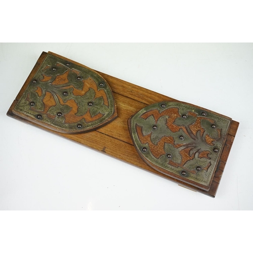 154 - An antique oak book slide with metal pierced floral decoration.