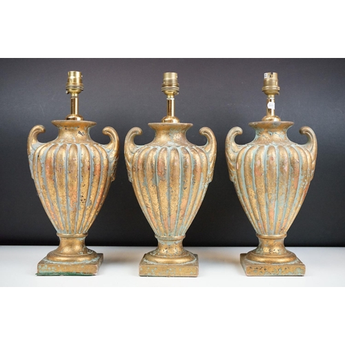 156 - A set of three terracotta lamps with gilt decoration.