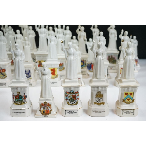 91 - 40 ceramic crested ware / goss figurines of Florence Nightingale, each with a town crest to the fron... 