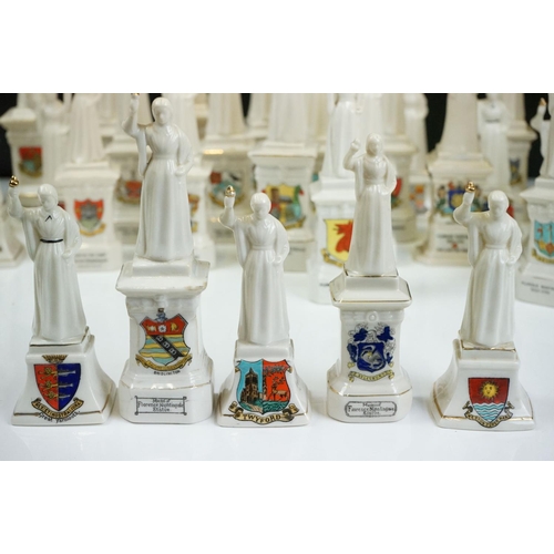 91 - 40 ceramic crested ware / goss figurines of Florence Nightingale, each with a town crest to the fron... 