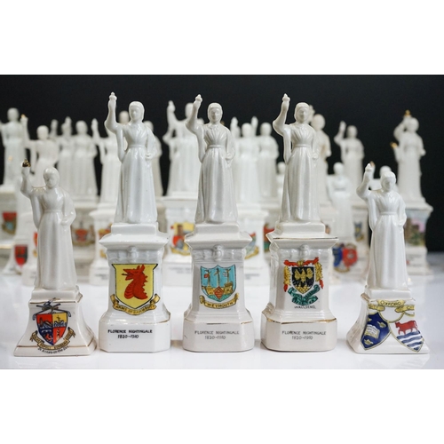 91 - 40 ceramic crested ware / goss figurines of Florence Nightingale, each with a town crest to the fron... 