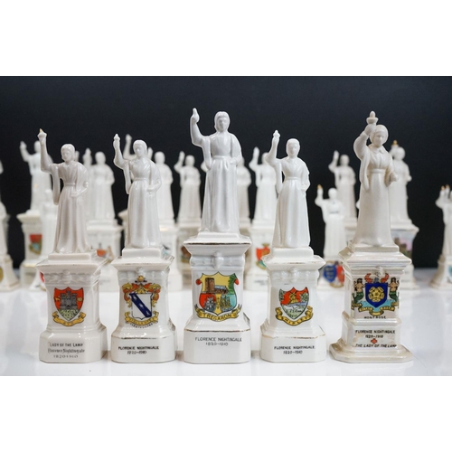 91 - 40 ceramic crested ware / goss figurines of Florence Nightingale, each with a town crest to the fron... 