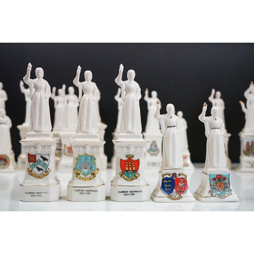 91 - 40 ceramic crested ware / goss figurines of Florence Nightingale, each with a town crest to the fron... 