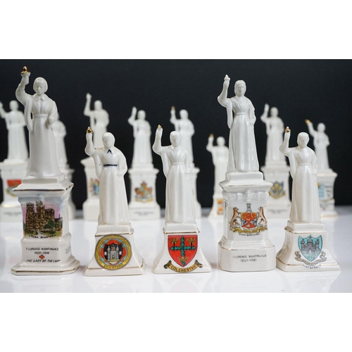 91 - 40 ceramic crested ware / goss figurines of Florence Nightingale, each with a town crest to the fron... 