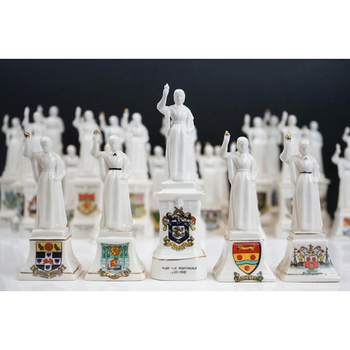 94 - 35 ceramic crested ware / goss figurines of Florence Nightingale, each with a town crest to the fron... 