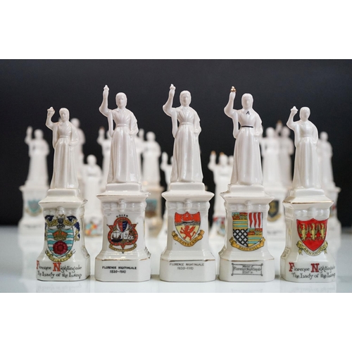 94 - 35 ceramic crested ware / goss figurines of Florence Nightingale, each with a town crest to the fron... 