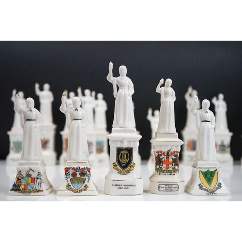 94 - 35 ceramic crested ware / goss figurines of Florence Nightingale, each with a town crest to the fron... 