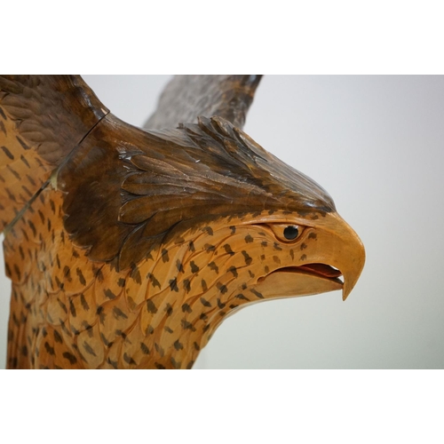 170 - Carved wooden eagle statue carved with out stretched wings with painted detailing raised on a wooden... 