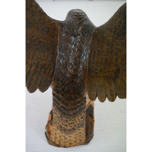 170 - Carved wooden eagle statue carved with out stretched wings with painted detailing raised on a wooden... 