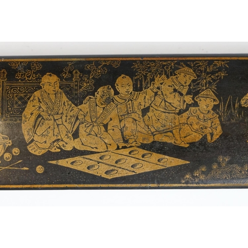 175 - Japanese Black Lacquered Pen Box, the hinged lid with gilt chinoiserie decoration opening to two pen... 