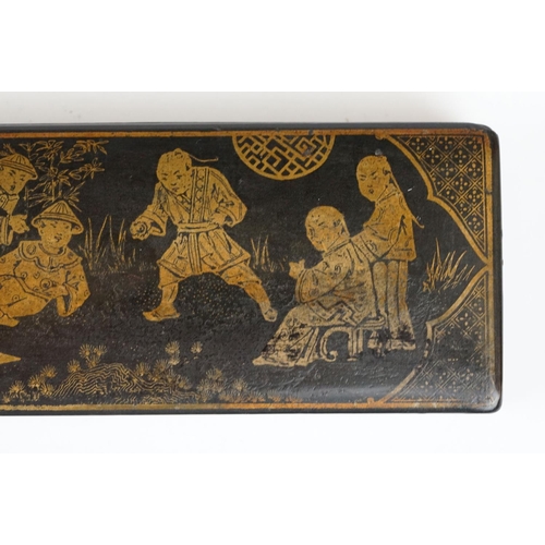 175 - Japanese Black Lacquered Pen Box, the hinged lid with gilt chinoiserie decoration opening to two pen... 