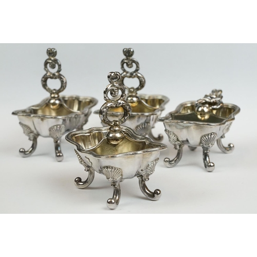 200 - A set of four Italian silver boat shaped salt cellars, on scroll feet.